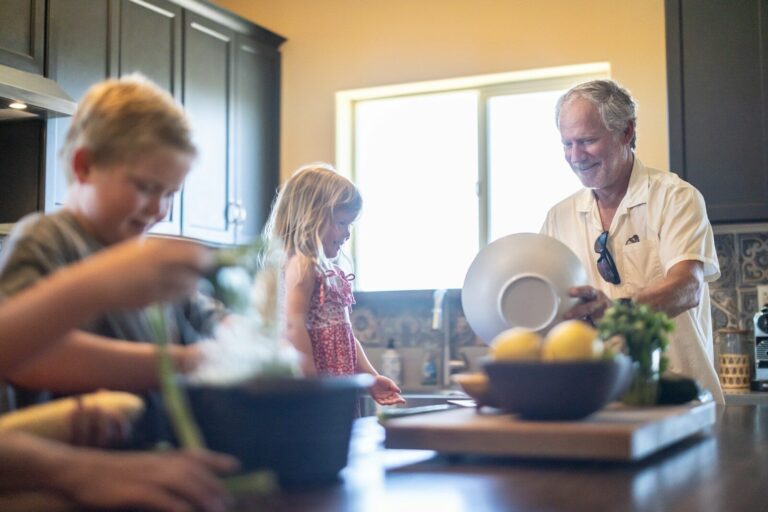 Family preparing food together at home as part of a realistic January wellness routine